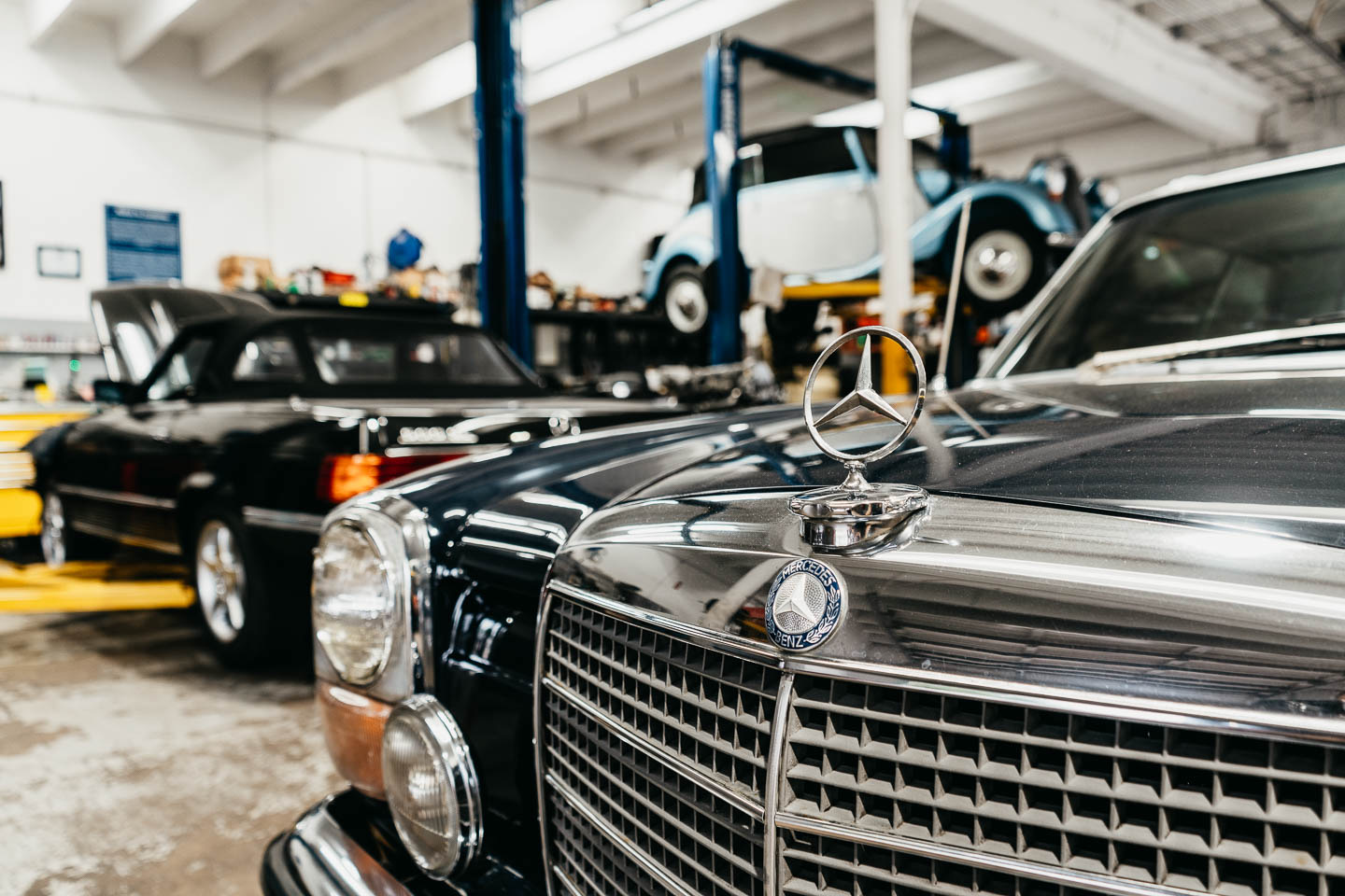 Classic Mercedes-Benz in European workshop with vintage cars