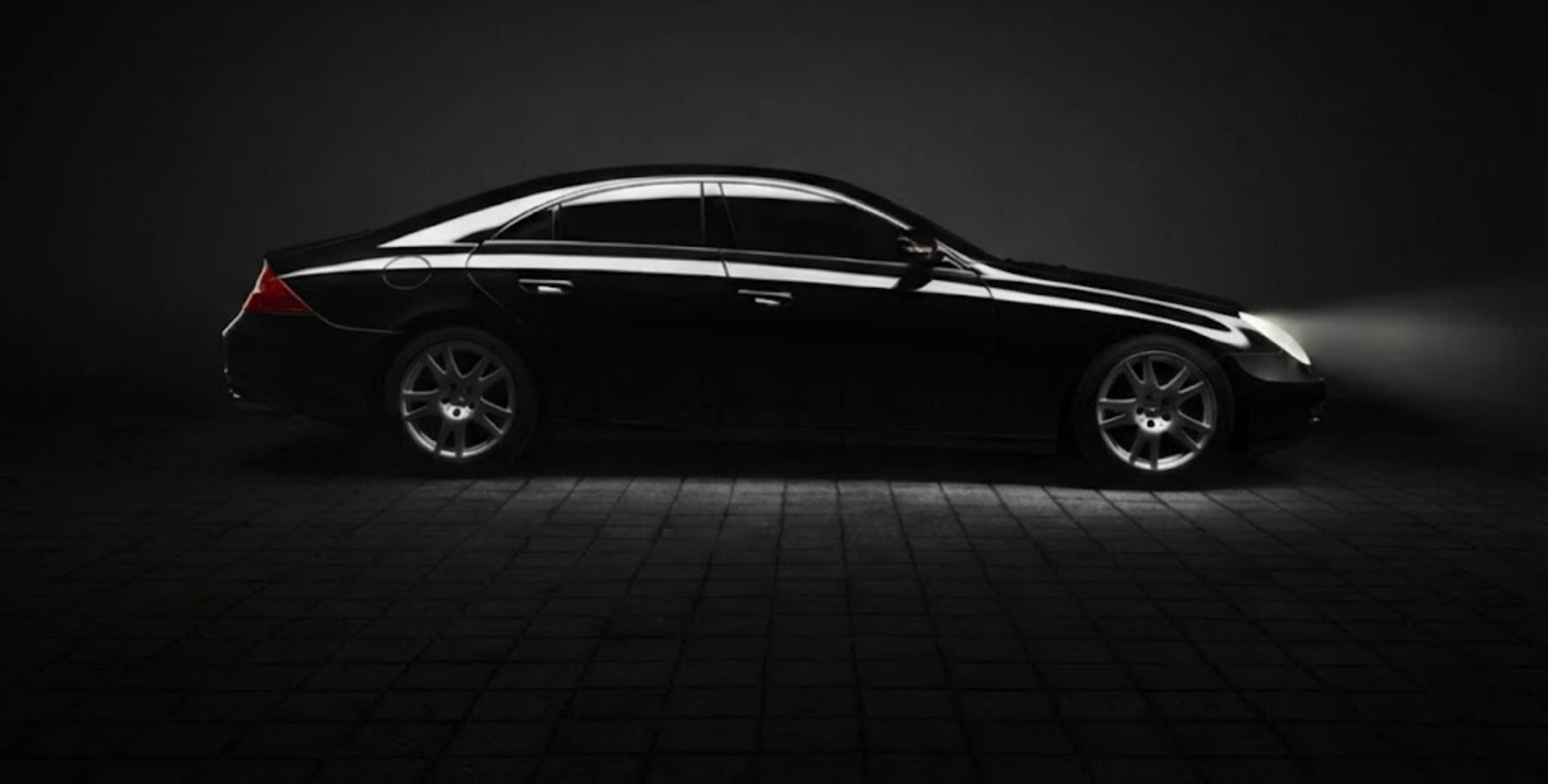 Premium black luxury sedan side profile